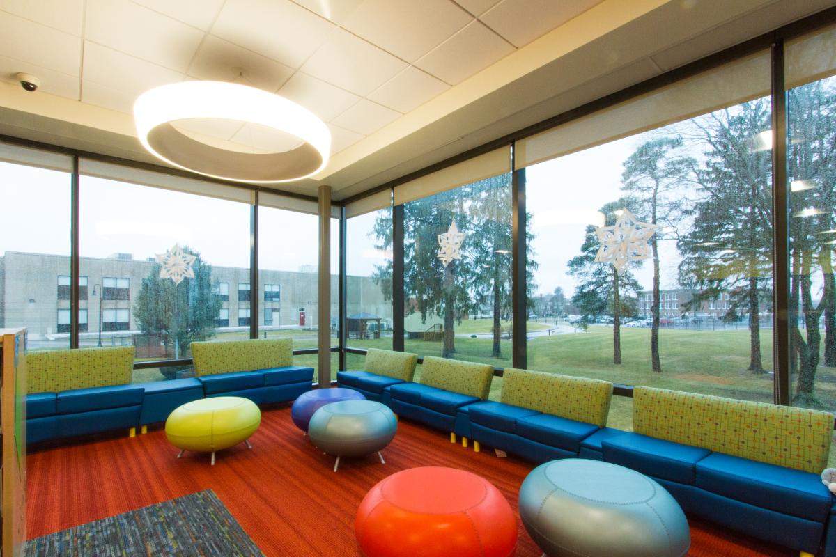 Variety of Funky Chairs Next to Large Exterior Windows
