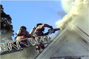 Firefighters Cut Into Roof with Chainsaw